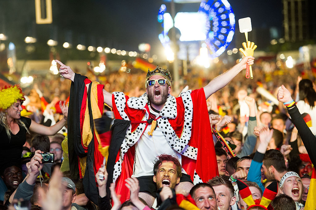 BERLIN, GERMANY - JULY 13: Fans of Germany cheer after Mario Goetze scored for Germany during the 2014 FIFA World Cup Final between Germany and Argentina at the Fanmeile public viewing at Brandenburg Gate on July 13, 2014 in Berlin, Germany. (Photo by Target Presse Agentur Gmbh/Bongarts/Getty Images)