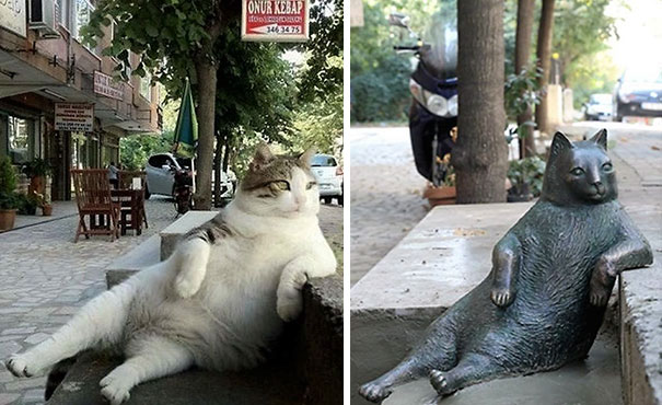 Katze lehnt am Straßenrand (Statue)