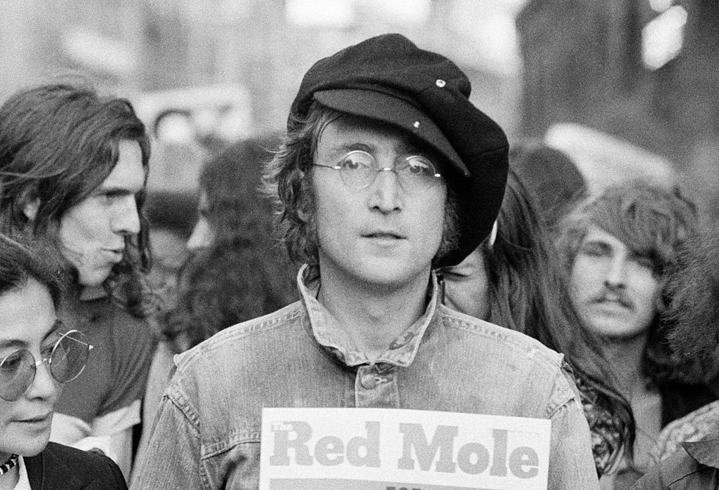 Portrait of British musician John Lennon (1940 - 1980) (center) and his wife, artist and musician Yoko Ono (extreme left) as they attend an unspecified rally in Hyde Park, London, England, 1975. (Photo by Rowland Scherman/Getty Images)