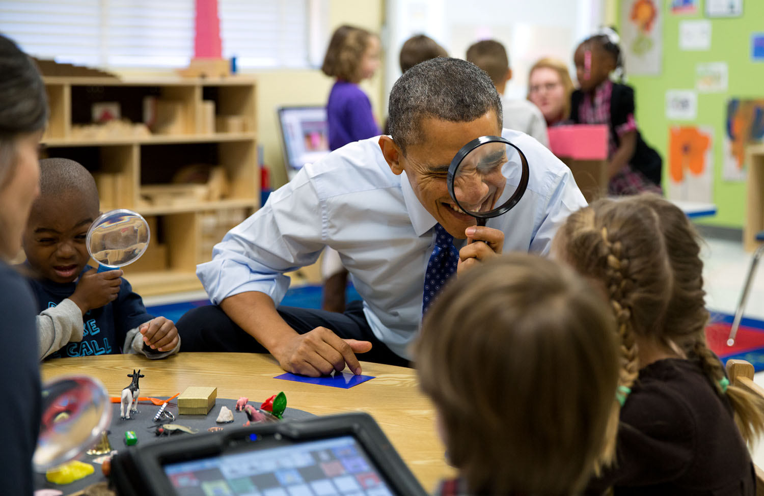 Feb. 14, 2013 "The President genuinely enjoys being with kids. Here, he played a magnifying glass game with children during a visit to a pre-kindergarten classroom at the College Heights Early Childhood Learning Center in Decatur, Georgia." (Official White House Photo by Pete Souza) This official White House photograph is being made available only for publication by news organizations and/or for personal use printing by the subject(s) of the photograph. The photograph may not be manipulated in any way and may not be used in commercial or political materials, advertisements, emails, products, promotions that in any way suggests approval or endorsement of the President, the First Family, or the White House.