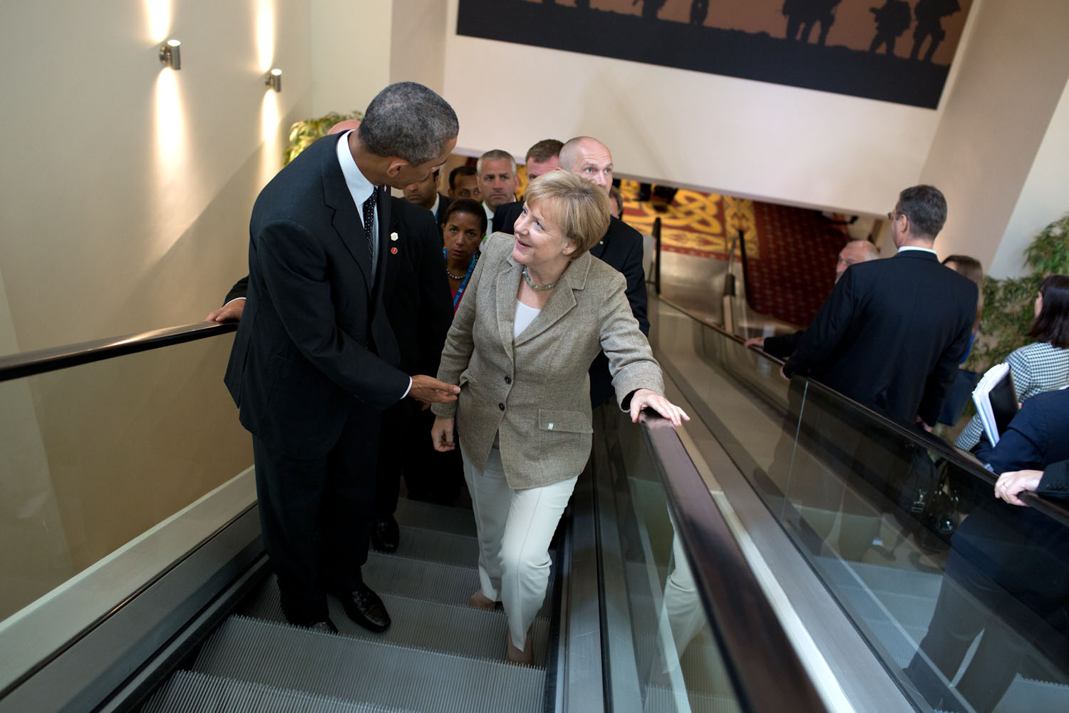 Sept. 4, 2014 "Meetings happen everywhere including on the escalator. Here, the President continues a conversation with German Chancellor Angela Merkel following their meeting with other leaders at the NATO Summit in Newport, Wales." (Official White House Photo by Pete Souza) This official White House photograph is being made available only for publication by news organizations and/or for personal use printing by the subject(s) of the photograph. The photograph may not be manipulated in any way and may not be used in commercial or political materials, advertisements, emails, products, promotions that in any way suggests approval or endorsement of the President, the First Family, or the White House.