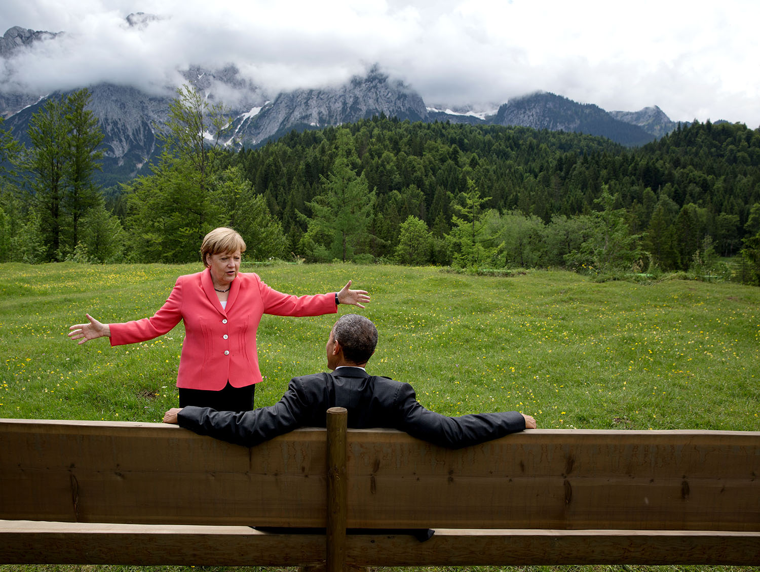 June 8, 2015 "We were at the G7 Summit in Krün, Germany. Chancellor Angela Merkel asked the leaders and outreach guests to make their way to a bench for a group photograph. The President happened to sit down first, followed closely by the Chancellor. I only had time to make a couple of frames before the background was cluttered with other people." (Official White House Photo by Pete Souza) This official White House photograph is being made available only for publication by news organizations and/or for personal use printing by the subject(s) of the photograph. The photograph may not be manipulated in any way and may not be used in commercial or political materials, advertisements, emails, products, promotions that in any way suggests approval or endorsement of the President, the First Family, or the White House.