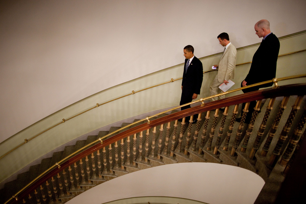 President Barack Obama walks down a spiral staircase with Deputy Director of Oval Office Operations Brian Mosteller after taping his weekly address in the Eisenhower Executive Office Building in Washington, July 24, 2009. (Official White House Photo by Chuck Kennedy) This official White House photograph is being made available for publication by news organizations and/or for personal use printing by the subject(s) of the photograph. The photograph may not be manipulated in any way or used in materials, advertisements, products, or promotions that in any way suggest approval or endorsement of the President, the First Family, or the White House.