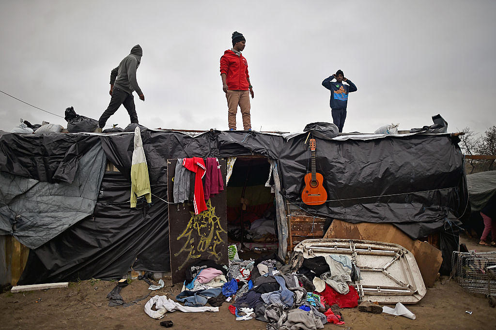 CALAIS, FRANCE - DECEMBER 01: Migrants contend with wintery conditions in the camp known as the 'New Jungle' on December 1, 2015 in Calais, France. Thousands of migrants continue to live in the makeshift camp in the port town in northern France, where they continue to try and board vehicles heading for ferries or through the tunnel in an attempt to reach Britain. (Photo by Jeff J Mitchell/Getty Images)