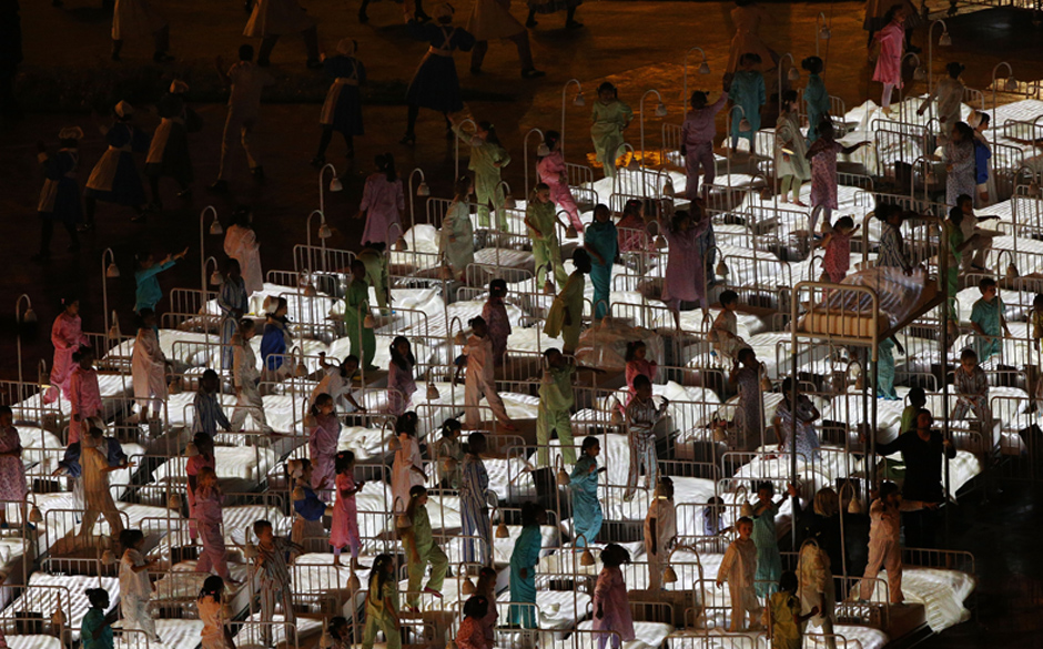 LONDON, ENGLAND - JULY 27:  People perform during the Opening Ceremony of the London 2012 Olympic Games at the Olympic Sta...