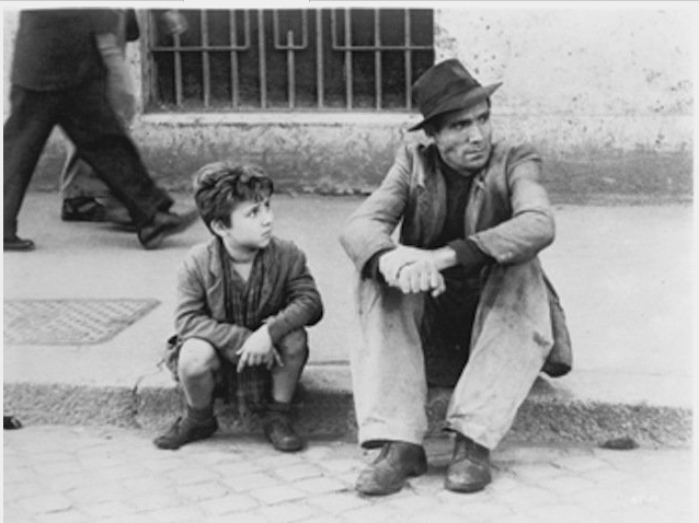 Schauspieler Lamberto Maggiorani und Enzo Staiola 1948 auf einem Bordstein in einer Szene aus FAHRRADDIEBE von Regisseur V...