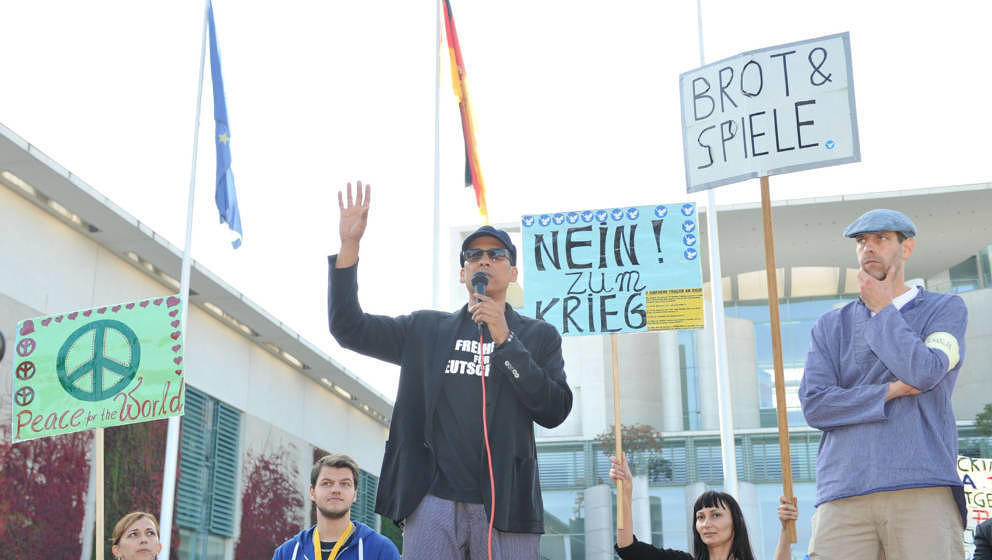 BERLIN, GERMANY - OCTOBER 3:  German Singer Xavier Naidoo speaks when a group of Germans gather outside the prime ministry to