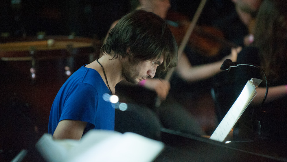 LONDON, UNITED KINGDOM - AUGUST 06: Jonny Greenwood looks on as he & The LCO  conducted by Hugh Brunt prepare to perform 