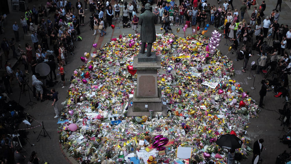 MANCHESTER, ENGLAND - MAY 25:  The carpet of floral tributes to the victims and injured of the Manchester Arena bombing cover