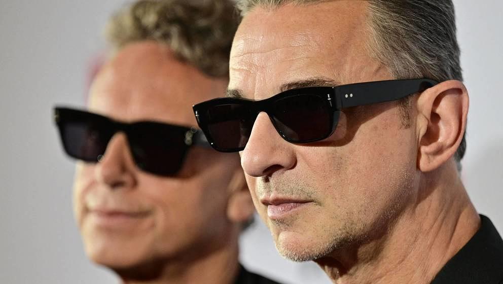 Members of the English electronic music band Depeche Mode, Martin Gore (L) and Dave Gahan, smile ahead of a press conference 