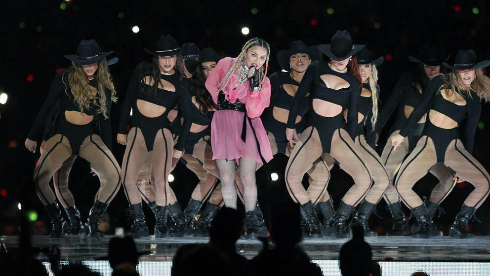 Pop icon Madonna (C) performs on stage with Colombian singer Maluma (out of frame) during his concert 'Medallo in the Map', i