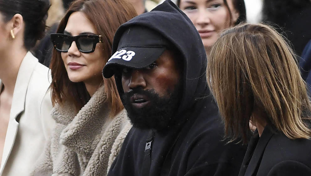 US rapper Kanye West (C), attends the Givenchy Spring-Summer 2023 fashion show during the Paris Womenswear Fashion Week, in P