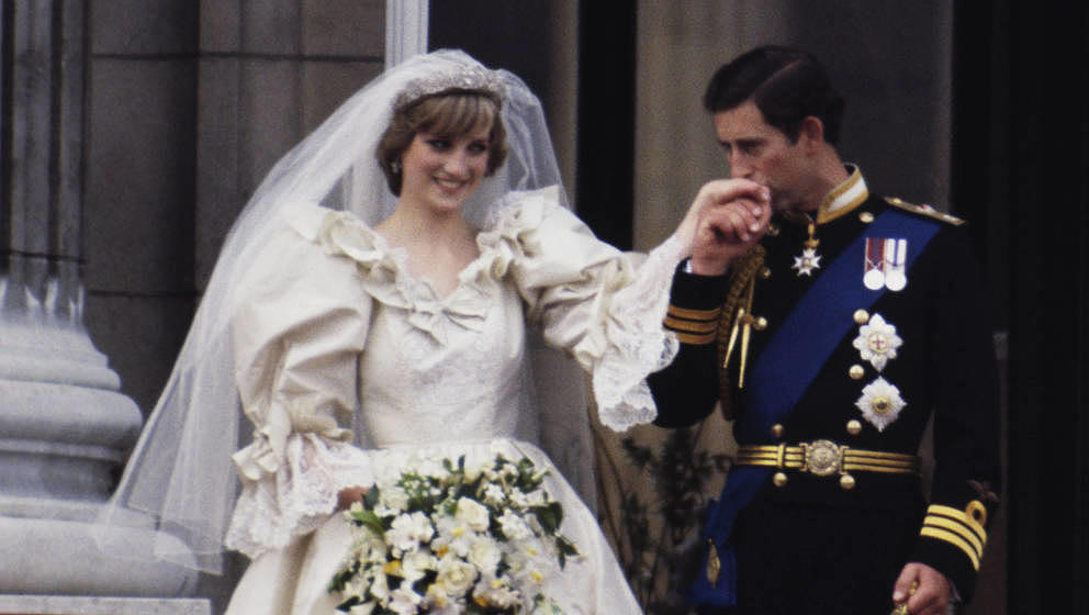 The Prince and Princess of Wales on the balcony of Buckingham Palace on their wedding day, 29th July 1981. Diana wears a wedd