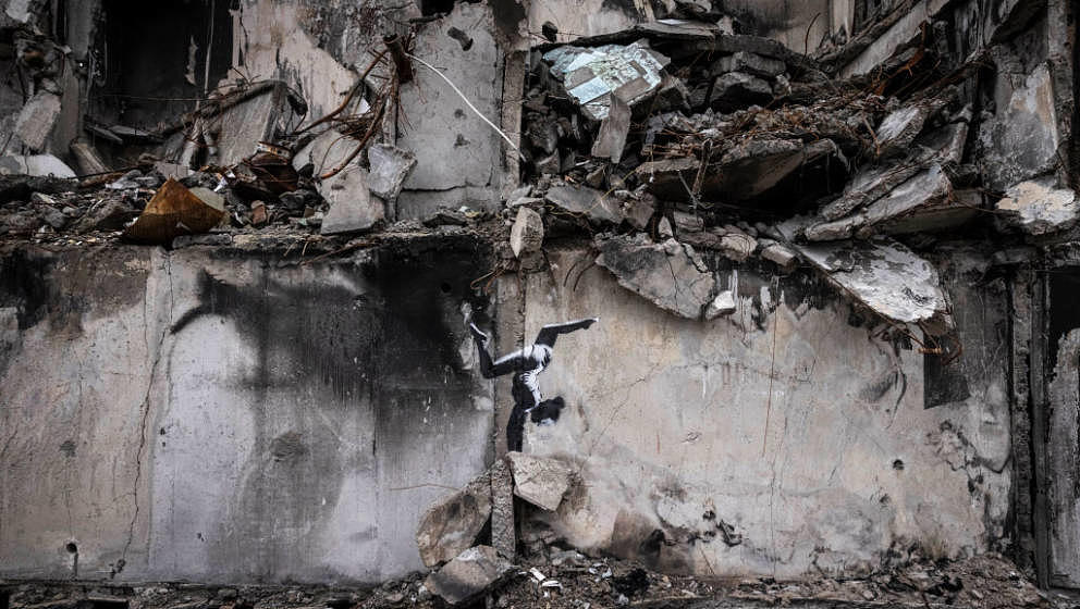 BORODYANKA, UKRAINE - NOVEMBER 11 Graffiti of a woman in a leotard doing a handstand is seen on the wall of a destroyed build